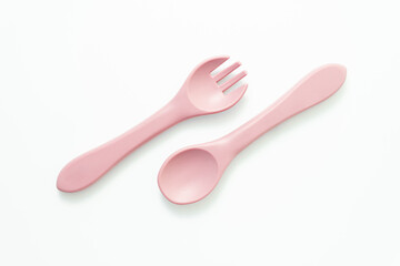 Cute pink baby utensils isolated on white. Ideal for feeding products, toddler dining tools, or baby care visuals.