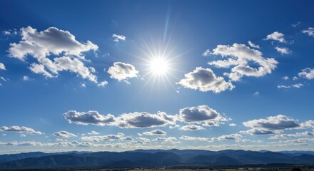 Obraz premium Sunny sky above mountains representing hope and freedom with clouds and sunlight