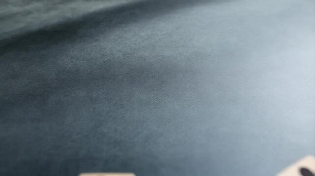 Wooden blocks with business people icons scattered on a gray surface creating a pattern effect