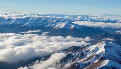 Obraz premium Breathtaking mountain range overlooking clouds high altitude aerial view nature's majesty