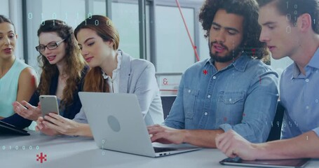 Colleagues reviewing technology content on devices in office, showing floating binary code overlay - Powered by Adobe