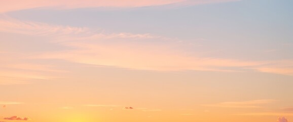 Fototapeta premium Soft pastel sky with orange yellow and light blue gradient colors.