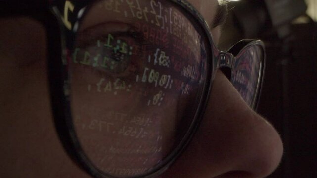Close up of tired woman working at night on laptop, girl in eye glasses with reflections overworking busy, using computer in dark office