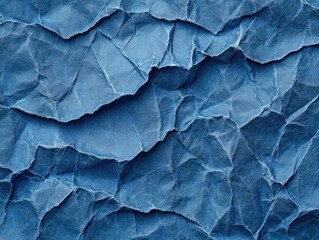 Fototapeta premium Close-up of crumpled blue textured paper with multiple folds and creases creating an abstract pattern