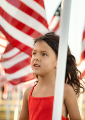 Summer portrait of child with American flags on a Memorial Day, USA National holiday