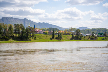 View from the Love Stone over the Biya River with the town of Turochak on the opposite bank. Concept of serenity, connection, and sacred places in wild Russian nature
