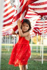 Happy American child holding flag on Memorial Day outdoor, National Holiday concept