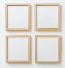 Four Empty Light Brown Square Wooden Picture Frames On A White Wall