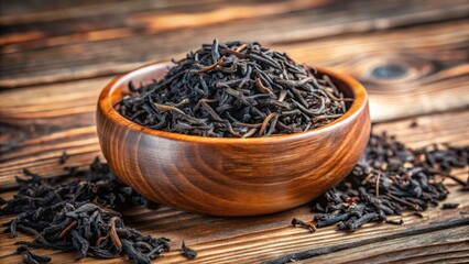 Fototapeta premium Dried black tea leaves in a wooden bowl, wooden, traditional, wooden, traditional, landscape, tea leaves, outdoors