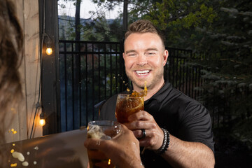 Friends celebrating and cheering with beer pints for National Beer Lover's Day.