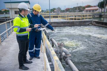 A professional inspector and a water treatment plant engineer are working together to check whether...
