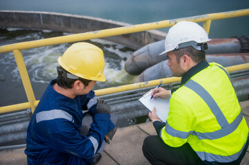 An inspector and a water treatment plant engineer are working together to plan a change in the...