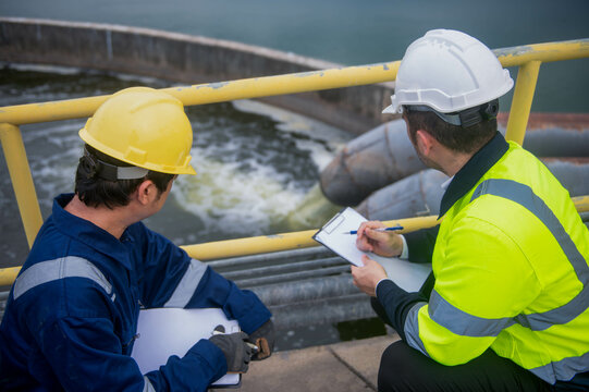 An inspector and a water treatment plant engineer are working together to plan a change in the treatment plant's water filter to bring the water up to state standards.