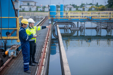 An inspector and an engineer at a water treatment plant are working together to plan the installation of additional water filters to make the water cleaner and safe for household use.