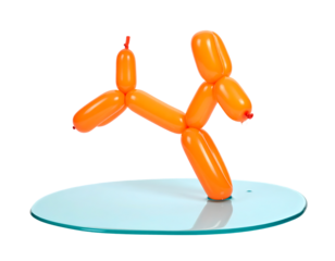 Orange Balloon Dog Figure on Light Blue Surface