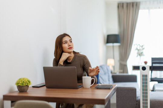 Image of young asian happy cheerful cute beautiful business Asian woman sit indoors in home office using laptop computer work in a video conference on line