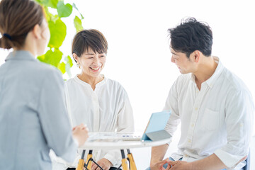 スーツ姿の女性からインテリアの説明を受ける夫婦