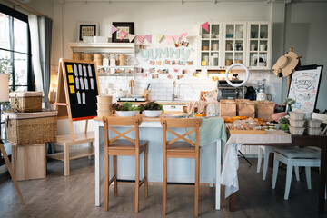 Cozy kitchen workshop filled with handmade bakery goods, fresh ingredients, takeaway packaging, vibrant decorations creating for home baking, cooking classes small business inspiration