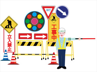 工事現場で交通誘導員が車に注意を促している。