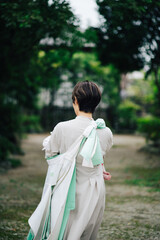 お宮参りで赤ちゃんを抱っこした女性の後ろ姿