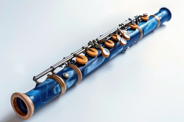 Naklejka premium A blue wooden flute with metal keys, designed for musical performance. on white background