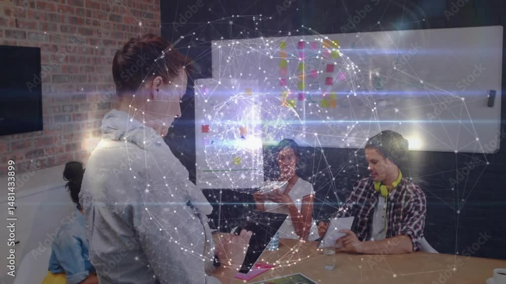 Poster team using tablet for business meeting while noting documents under glowing network overlay