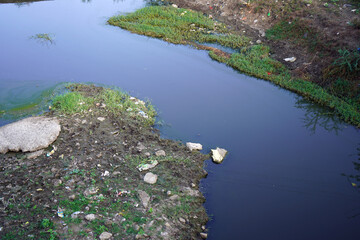 Discarded plastic garbage in a stream lake or river.
