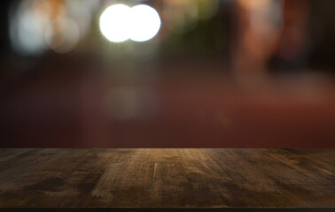 Empty wood table top and blur of restaurant background selective focus product display