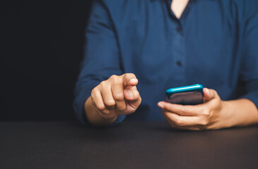 Man pointing forward while holding smartphone, concept of user interface, selection, or targeting.