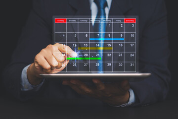 Businessman using tablet with holographic calendar interface, concept of planning and schedule.