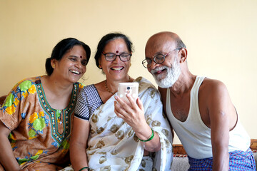 Indian family chatting on phone at home