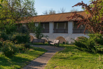 A picturesque park with benches on the territory of the Astrakhan Kremlin against the background of...