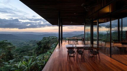 Fototapeta premium A restaurant balcony overlooking lush green mountains at dusk