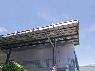 Low angle view, roof corner of shop food with gutters. blue sky background