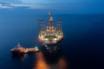 Aerial view of offshore jack up drilling rig during sunset - oil and gas industry.
