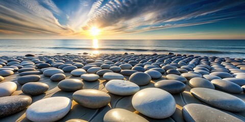 Fototapeta premium Serene Sunset Seascape Smooth, sun-kissed stones adorn a tranquil beach, reflecting the golden light of a breathtaking sunset over a calm ocean horizon.
