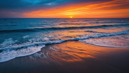 Obraz premium Golden sunlight reflects on the sea and wet sand during a vibrant sunset at the coast