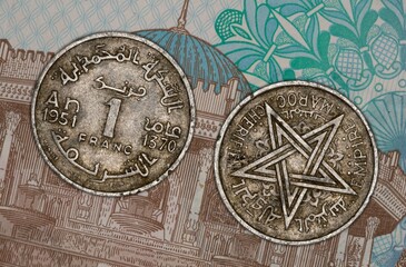 Close-up of a vintage Moroccan 1 franc coin from 1951 with Arabic script and star emblem