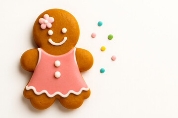 Cute Gingerbread Girl Cookie with Pink Dress and Flower Decoration on Minimal White Background with Colorful Candy Sprinkles – Adorable Holiday Treat in 16:9 Format