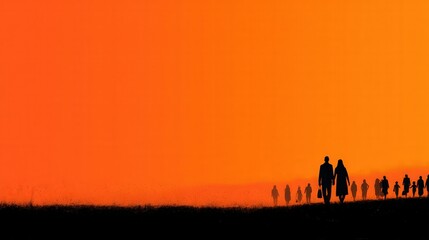 Fototapeta premium Silhouette Journey: A group of people, in silhouette against a vibrant orange sunset sky, walk towards the horizon, evoking themes of travel and togetherness.