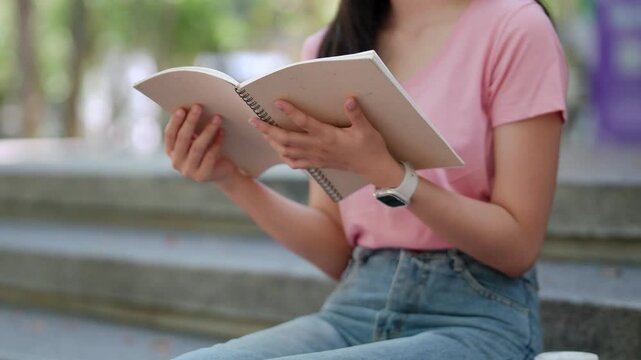 Quiet moments with a book: A moment of serenity as a woman sits absorbed in the pages of a book, enjoying a quiet moment of reading.