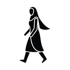 Silhouette of a woman wearing a hijab and walking in profile representing muslim culture and modesty