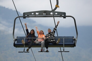 Joyful Friends on a Mountain Cable Car