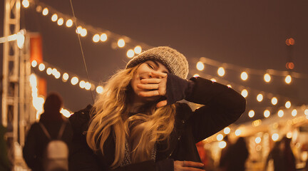 beautiful girl in winter hat near the Christmas tree, winter holidays, holiday and walks photo...