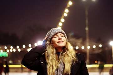 beautiful girl in winter hat near the Christmas tree, winter holidays, holiday and walks photo...