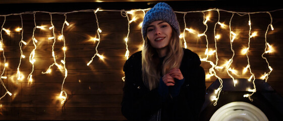 beautiful girl in winter hat near the Christmas tree, winter holidays, holiday and walks photo...