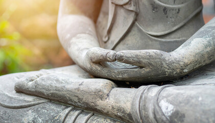 Close-up detail of a stone Buddha meditating, showcasing serenity and spiritual depth. Perfect for backgrounds aiming to evoke inner peace.
