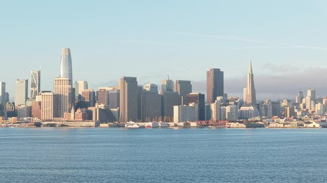 Sleek lines of urban development run parallel to the gentle arc of the waterfront in this high-elevation pass.