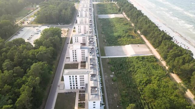 Aerial view of Prora on R&uuml;gen Island, showing the historic seaside resort stretching along the coast with the beach and Baltic Sea beside it.