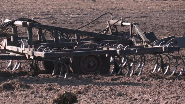 Farmer in tractor preparing land with seedbed cultivator as part of pre seeding activities in early spring season of agricultural works at farmlands. Farmer in tractor preparing land with seedbed cult